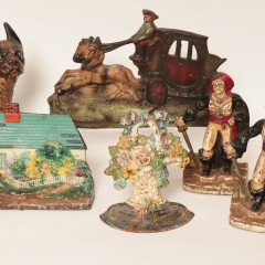 Collection of Hand Painted Cast Iron Doorstops Including a Boston Bulldog, Cottage, Fisheman, Flower Basket, Pirates, Coachmen and Horses, and Clippership