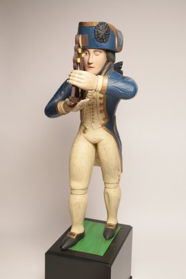 Folk art carved figure of Admiral Nelson holding an octant.