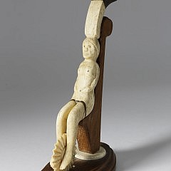 Whalebone Pie Crimper, circa 1850, a seated female nude with ponytail