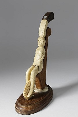 Whalebone Pie Crimper, circa 1850, a seated female nude with ponytail