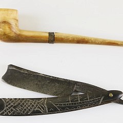 Two Sailor’s Accessories, 19th c., comprising a carved whale ivory pipe in two sections joined by a metal collar, and a straight edge with a baleen case engraved with whaling bark and fish, the steel edge by Hargreaves Smith & Co. Imperial Razor Sheffield