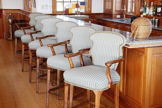 Four Walnut Upholstered Bar Height Armchairs