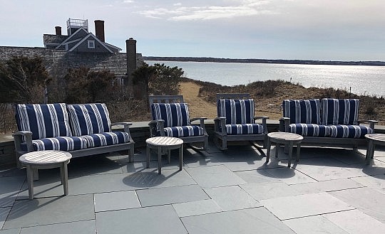 Pair of Gloster Teak Rocking Chairs and Two Gloster Teak Settees with Blue and White Cushions together with 4 Round Teak Side Tables