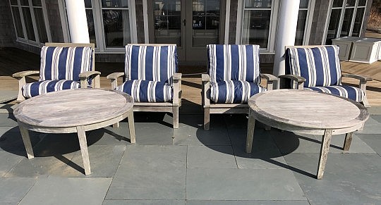 Four Gloster Teak Armchairs with Blue and White Striped Cushions and Two Large Round Cocktail Tables