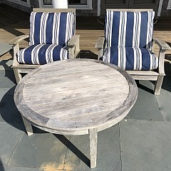 Four Gloster Teak Armchairs and Two Large Round Cocktail Tables