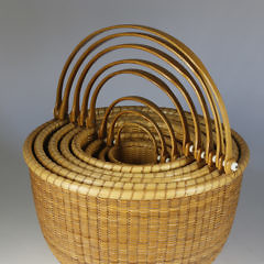 Nest of Eight Bill and Judy Sayle Round Open Swing Handle Nantucket Baskets, 1983