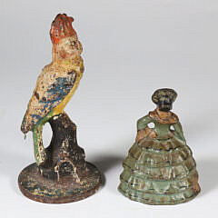 Two Antique Polychrome Cast Iron Doorstops, a Parrot and a Lady