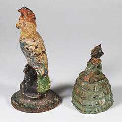 Two Antique Polychrome Cast Iron Doorstops, a Parrot and a Lady