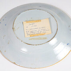 A Delft Blue and White Plate and Yellow Ground Delft Shallow Bowl, circa 1730