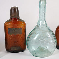 Nine Antique Bottles in Various Forms and Colors