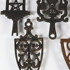 Collection of Six Sad Iron Trivets