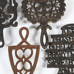 Collection of Six Sad Iron Trivets