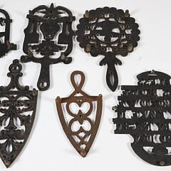 Collection of Six Sad Iron Trivets