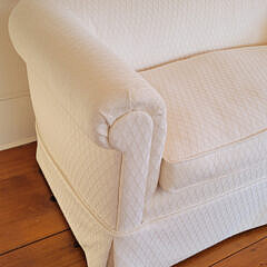 Designer Creme Upholstered Single Cushion Skirted Settee with Rolled Arms