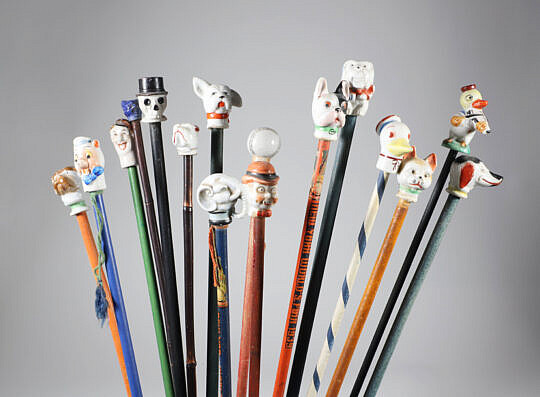 Collection of 16 Assorted Porcelain and Wood Carnival Walking Sticks 