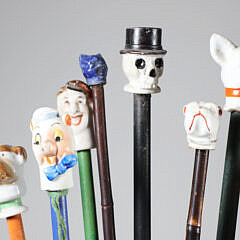 Collection of 16 Assorted Porcelain and Wood Carnival Walking Sticks