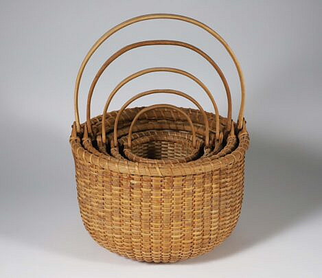 Contemporary Nest of Five Nantucket Open Baskets, round form with swing handles and copper pins, each with interior concentric circles, and basket branding on exterior base 