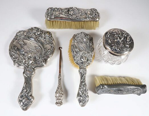Five Piece Sterling Silver Art Nouveau Dresser Set, stamped WM B. Kerr, Newark NJ including a hand mirror, three brushes, cut glass covered jar and boot lace pull 