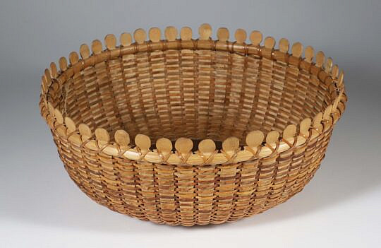 Contemporary Round Nantucket Lollipop Basket, round open form with interior plate having 12 concentric circles, exterior base with branded basket