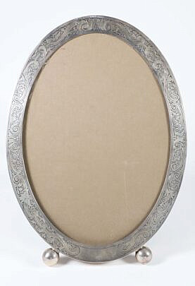 Gorham Sterling Silver Oval Easel Frame, engraved with one inch scrolls, on ball feet