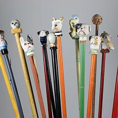 Collection of 16 Assorted Porcelain and Wood Carnival Walking Sticks 
