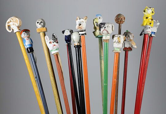 Collection of 16 Assorted Porcelain and Wood Carnival Walking Sticks 