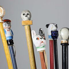 Collection of 16 Assorted Porcelain and Wood Carnival Walking Sticks