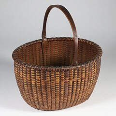 Fine Mid 19th Century Open Oval Swing Handle Nantucket Basket with Carved Wood Ears extending to the base plate