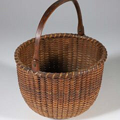 Antique Round Open Swing Handle Nantucket Basket, 19th Century, finely woven with carved wood ears and handle, incised concentric circles on the interior base
