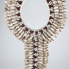 Papua Cowie Shell Bib Necklace on Custom Stand