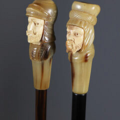 Two Carved Horn and Antique Ivory Face Grip Walking Sticks, 19th Century