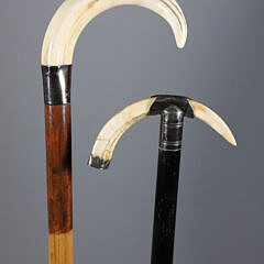 Two Boar’s Tusk C-Grip Canes, 19th Century, with Silver Mounts