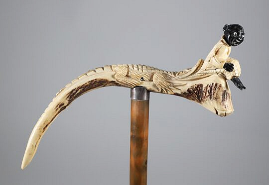 Carved Horn Alligator Tugging on Child