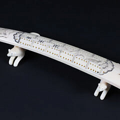Inuit Carved and Scrimshaw Walrus Tusk Cribbage Board on Carved Wolf Feet