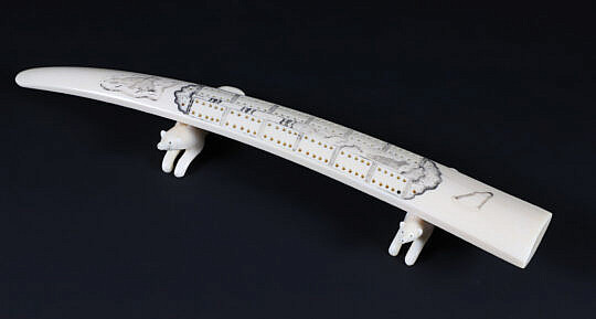 Inuit Carved and Scrimshaw Walrus Tusk Cribbage Board on Carved Wolf Feet