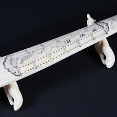 Inuit Carved and Scrimshaw Walrus Tusk Cribbage Board on Carved Wolf Feet