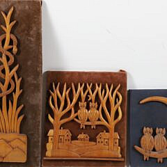 Group of Three Folk Art Carvings Mounted to Fabric Boards