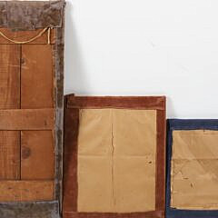 Group of Three Folk Art Carvings Mounted to Fabric Boards