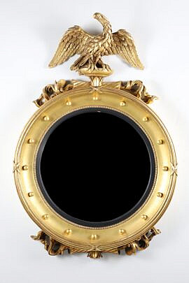 Regency Style Carved and Gilded Convex Mirror with Surmounted Spread Winged Eagle on a Plinth