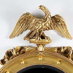 Regency Style Carved and Gilded Convex Mirror with Surmounted Spread Winged Eagle