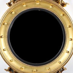 Regency Style Carved and Gilded Convex Mirror with Surmounted Spread Winged Eagle